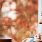 Woman enjoying coffee and fall colors.