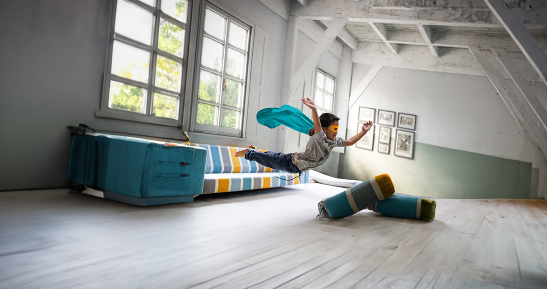 Child jumping through the air in a comfy house