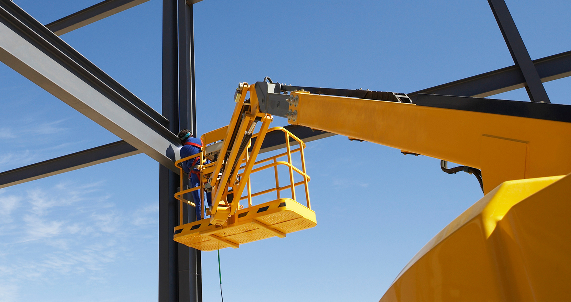 man in a lift welding