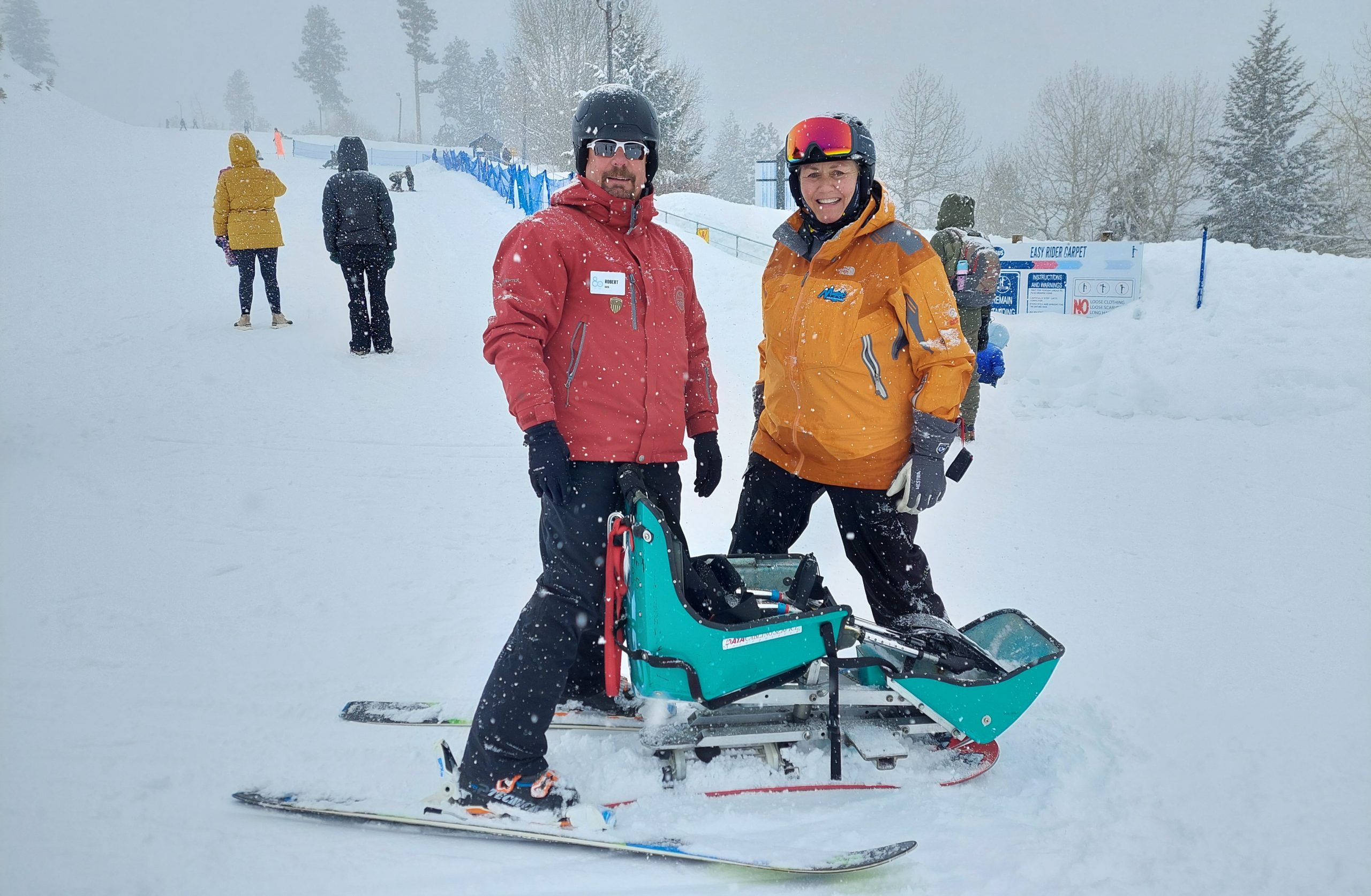 Employee Robert Walters and woman with an adaptive snow ski
